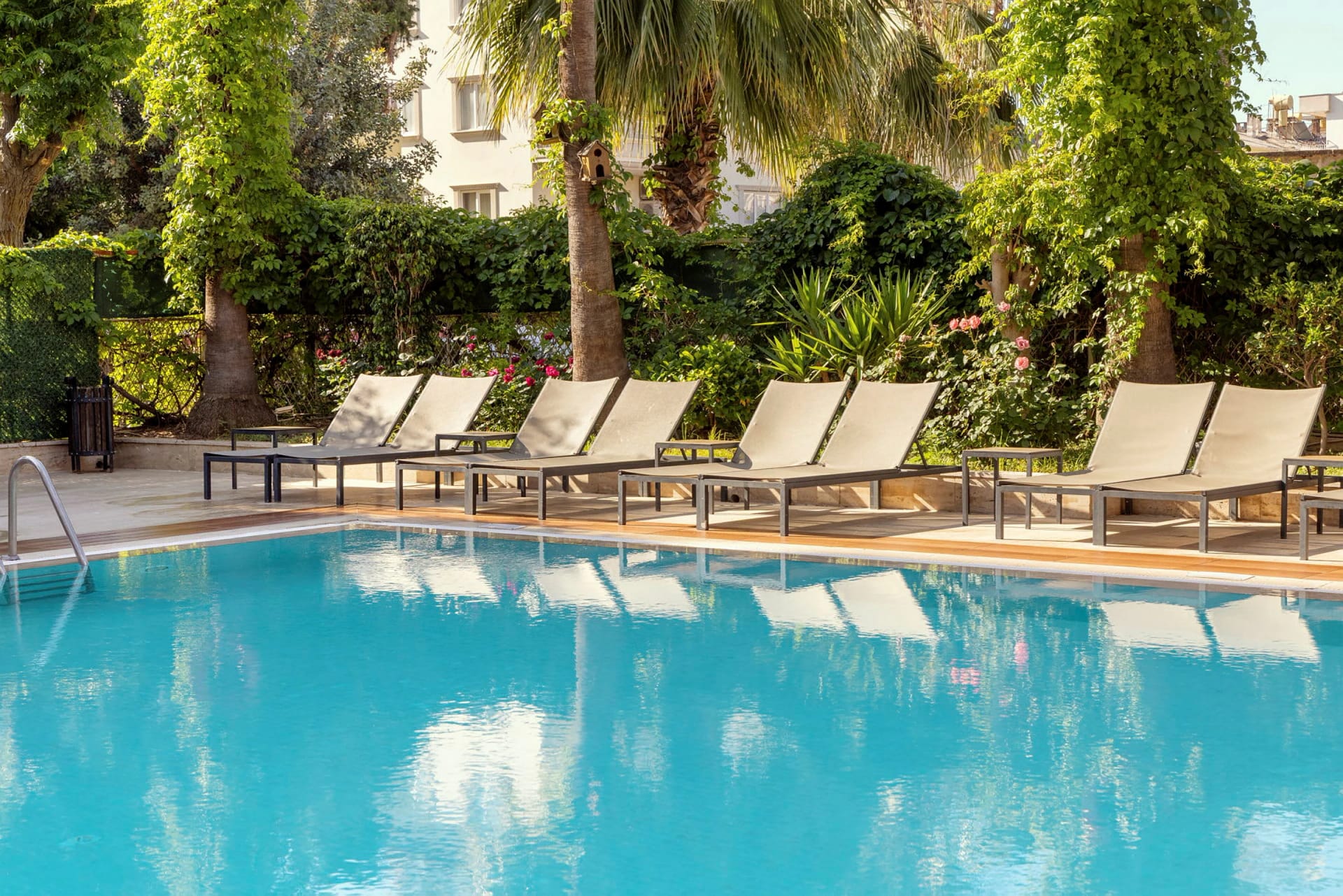 Sun loungers lining the outdoor pool at Prince Alanya Apart Hotel